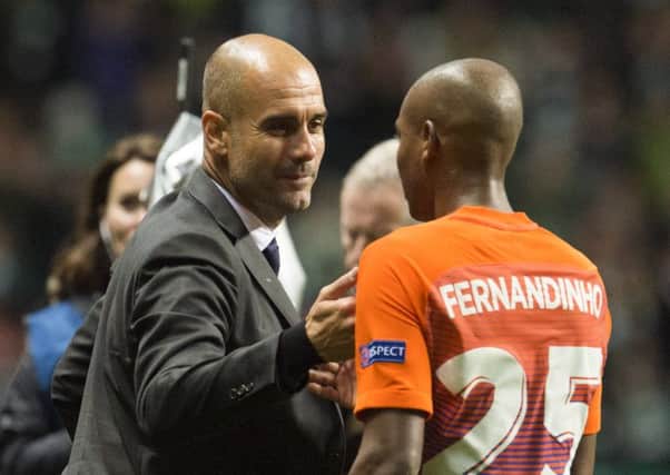 Manchester City manager Pep Guardiola (left) with Fernandinho at full-time. Picture: SNS