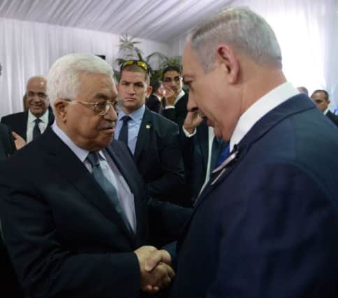 Israeli Prime Minister Benjamin Netanyahu shakes hands with Palestinian Authority President Mahmoud Abbas during the funeral of former Israeli leader Shimon Peres. Picture; Getty