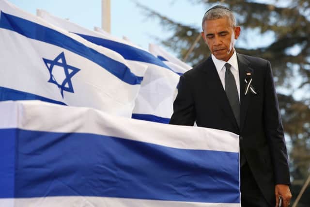 US President Barack Obama touches the coffin of former Israeli president and prime minister Shimon Peres. Picture; Getty