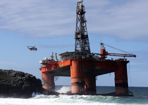 A coastguard helicopter winches a salvage expert onboard the Transocean Winner drilling rig. Andrew Milligan/PA Wire