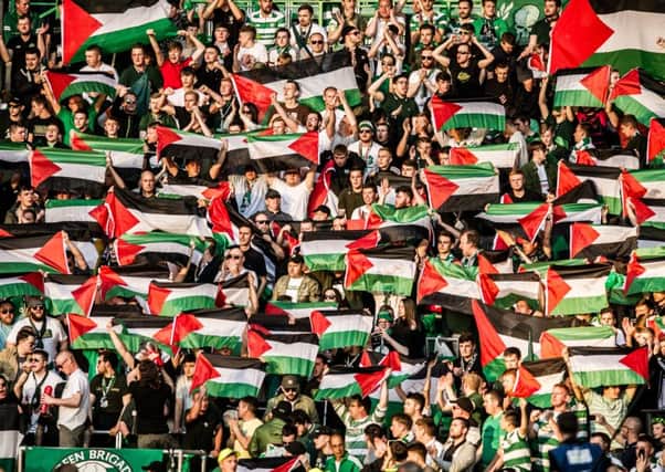 Celtic fans  protest with Palestinian flags inside the stadium.  Picture: John Devlin