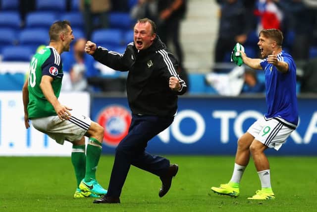 Michael O'Neill, centre, celebrates with Aaron Hughes, left, and Jamie Ward after Northern Ireland's second goal in the Euro 2016 Group C match against Ukraine in Lyon. Picture: Getty