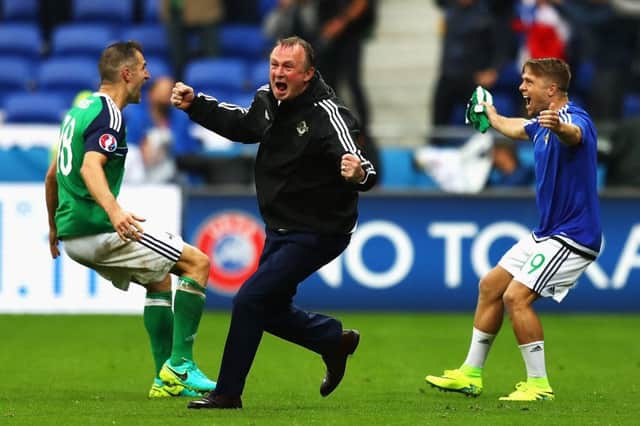 Michael O'Neill, centre, celebrates with Aaron Hughes, left, and Jamie Ward after Northern Ireland's second goal in the Euro 2016 Group C match against Ukraine in Lyon. Picture: Getty