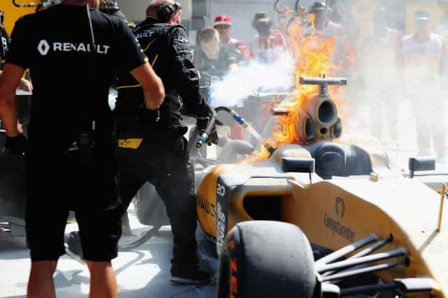 KUALA LUMPUR, MALAYSIA - SEPTEMBER 30:  The car of Kevin Magnussen of Denmark and Renault Sport F1 on fire in the Pitlane during practice for the Malaysia Formula One Grand Prix at Sepang Circuit on September 30, 2016 in Kuala Lumpur, Malaysia.  (Photo by Mark Thompson/Getty Images)***BESTPIX***