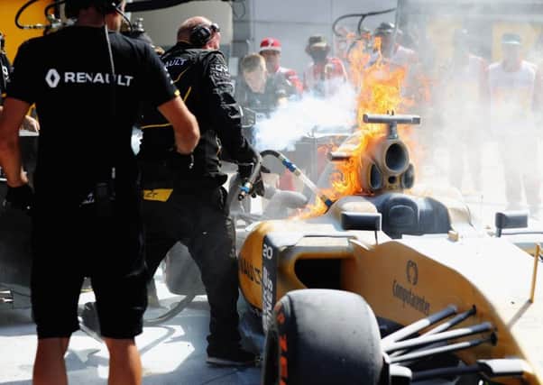 KUALA LUMPUR, MALAYSIA - SEPTEMBER 30:  The car of Kevin Magnussen of Denmark and Renault Sport F1 on fire in the Pitlane during practice for the Malaysia Formula One Grand Prix at Sepang Circuit on September 30, 2016 in Kuala Lumpur, Malaysia.  (Photo by Mark Thompson/Getty Images)***BESTPIX***