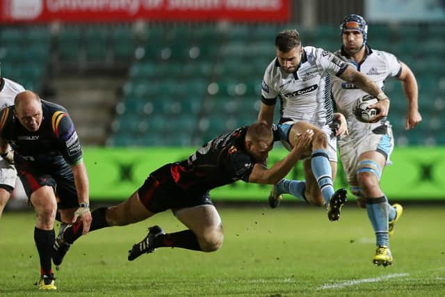 Glasgow winger Rory Hughes tries to skip out of a tackle by Jack Dixon of Newport Gwent Dragons. Picture: Fotosport