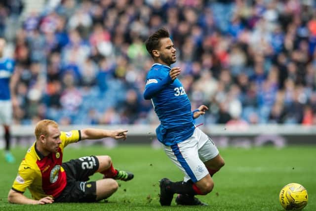 Partick's Ziggy Gordon tackles Harry Forrester of Rangers. Picture: John Devlin