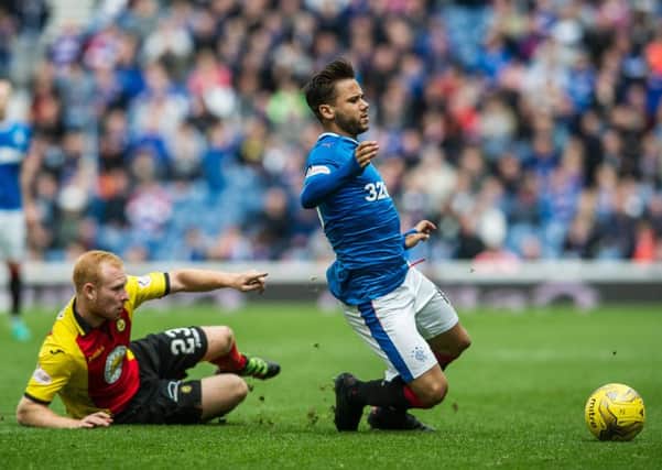 Partick's Ziggy Gordon tackles Harry Forrester of Rangers. Picture: John Devlin