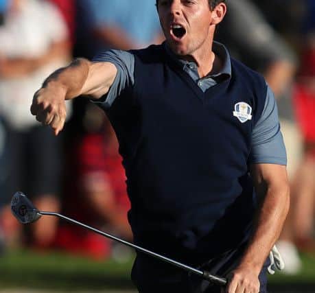 Rory McIlroy roars with delight after holing an eagle putt to close out his afternoon win in the company of Thomas Pieters. Picture: PA