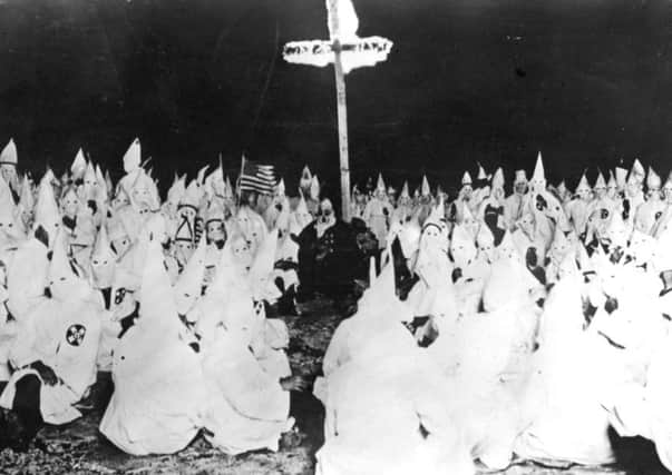November 1922:  A midnight meeting of the American white supremicist movement, the Ku Klux Klan.  (Photo by Topical Press Agency/Getty Images)
