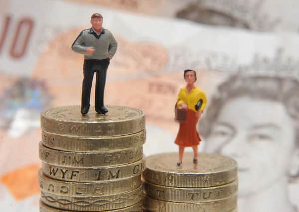 File photo dated 27/01/15 of plastic models of a man and woman standing on a pile of coins and bank notes, as a report has revealed that narrowing the yawning salary gap between men and women could bolster the UK economy by hundreds of billions of pounds. PRESS ASSOCIATION Photo. Issue date: Thursday September 29, 2016. Research by McKinsey Global Institute found that more than £600 billion, or 26%, could be pegged on to gross domestic product (GDP) in 2025 if women and men played an identical role in the UK labour market. See PA story ECONOMY Pay. Photo credit should read: Joe Giddens/PA Wire