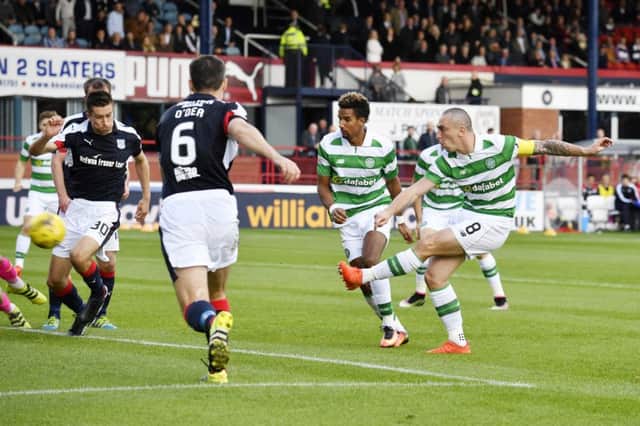 Captain fantastic: Scott Brown powers in the only goal of the game as Celtic earn win at Dens Park. Photograph: Rob Casey/SNS