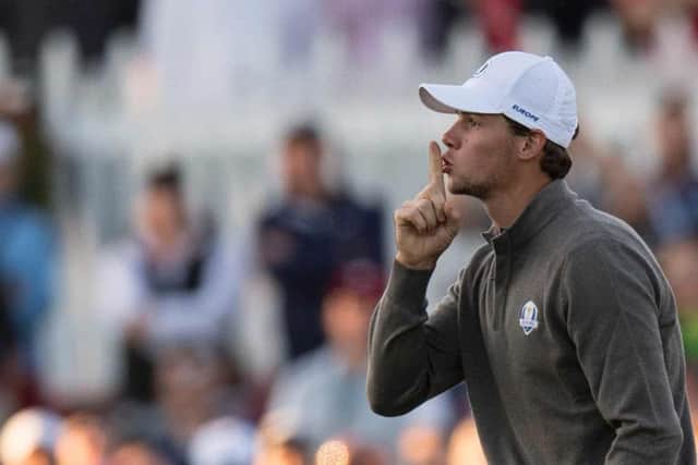 Thomas Pieters hushes the crowd after sinking a putt for an opening birdie. Photograph: Jim Watson/Getty