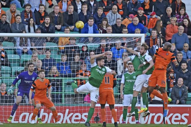 Dundee United's William Edjenguele heads his side level. Picture: SNS