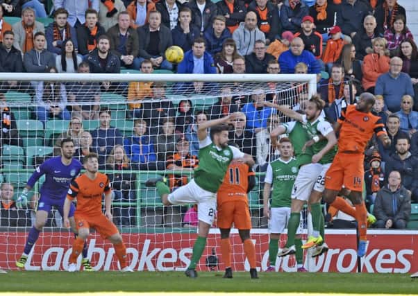 Dundee United's William Edjenguele heads his side level. Picture: SNS