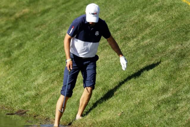Jordan Spieth dips his toe in the water as he attempts a stance over his ball on the 17th hole.  Picture: Streeter Lecka/Getty Images