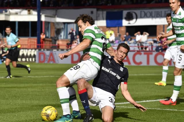 Dundee's Cameron Kerr (right) with a challenge on Celtic's Erik Sviatchenko inside the box. Picture: SNS