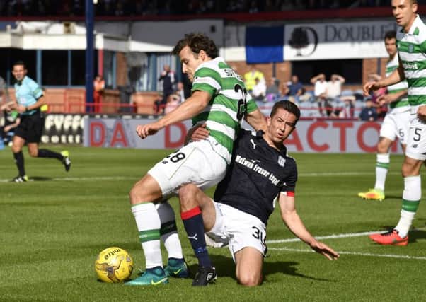 Dundee's Cameron Kerr (right) with a challenge on Celtic's Erik Sviatchenko inside the box. Picture: SNS