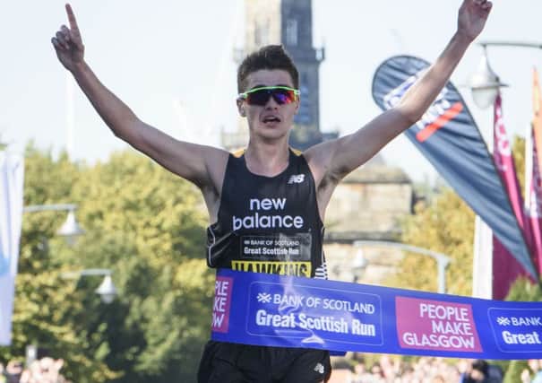 Scottish runner Callum Hawkins celebrates as he crosses the finishing line to win. Picture: PA