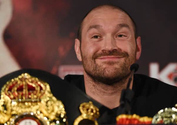 (FILES) This file photo taken on April 27, 2016 shows British heavyweight boxer Tyson Fury reacts during a press conference to publicise his forthcoming world heavyweight title fight against Ukranian heavyweight Wladimir Klitschko, at the Manchester Arena in Manchester, north-west England. Controversial world heavyweight champion Tyson Fury made an abrupt U-turn on his retirement decision on October 3, 2016, tweeting: "I'm here to stay." "Hahahaha u think you will get rid of the GYPSYKING that easy!!! I'm here to stay," Fury wrote on Twitter.he provocative 28-year-old British brawler, dogged by reports he failed a drugs test for cocaine, had earlier declared himself "retired" in a profanity-strewn tweet. / AFP PHOTO / OLI SCARFFOLI SCARFF/AFP/Getty Images