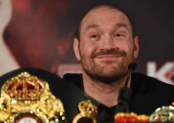 (FILES) This file photo taken on April 27, 2016 shows  British heavyweight boxer Tyson Fury reacts during a press conference to publicise his forthcoming world heavyweight title fight against Ukranian heavyweight Wladimir Klitschko, at the Manchester Arena in Manchester, north-west England. Controversial world heavyweight champion Tyson Fury made an abrupt U-turn on his retirement decision on October 3, 2016, tweeting: "I'm here to stay." "Hahahaha u think you will get rid of the GYPSYKING that easy!!! I'm here to stay," Fury wrote on Twitter.he provocative 28-year-old British brawler, dogged by reports he failed a drugs test for cocaine, had earlier declared himself "retired" in a profanity-strewn tweet. / AFP PHOTO / OLI SCARFFOLI SCARFF/AFP/Getty Images