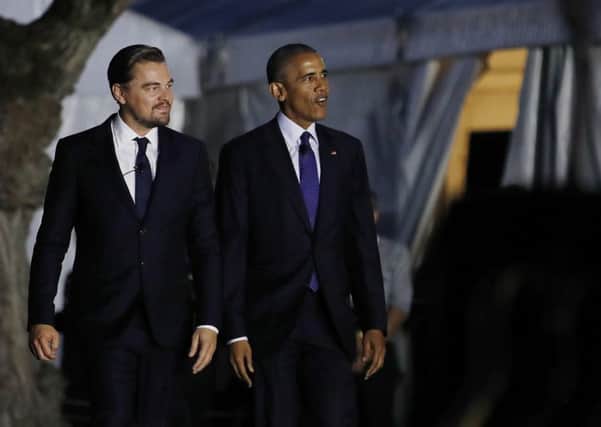 President Barack Obama and actor Leonardo DiCaprio walk to the stage to talk about climate change as part of the White House South by South Lawn event on the South Lawn of the White House in Washington. (AP Photo/Carolyn Kaster)