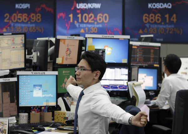 Currency traders in South Korea monitor the market as the pound falls to its lowest level since 1985. Picture: Ahn Young-joon/AP