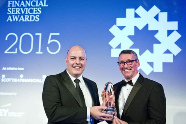 Royal Bank of Scotland head of entrepreneurship Gordon Merrylees, left, collects last year's award from Jim Duffy of Entrepreneurial Spark. Picture: Chris Watt
