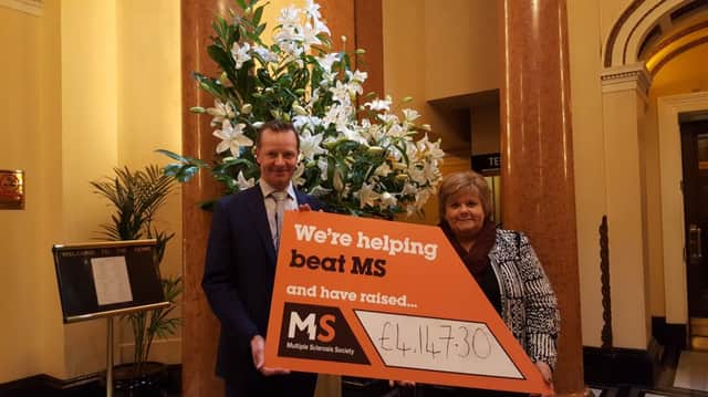 Steve Hall from The Dome presents a cheque to Moira Simpkins of MS Society Scotland. Picture: Contributed