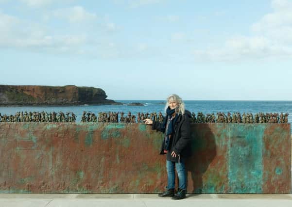 Sculptor Jill Watson with her Women And Bairns memorial at Eyemouth harbour. Photograph: Toby Williams