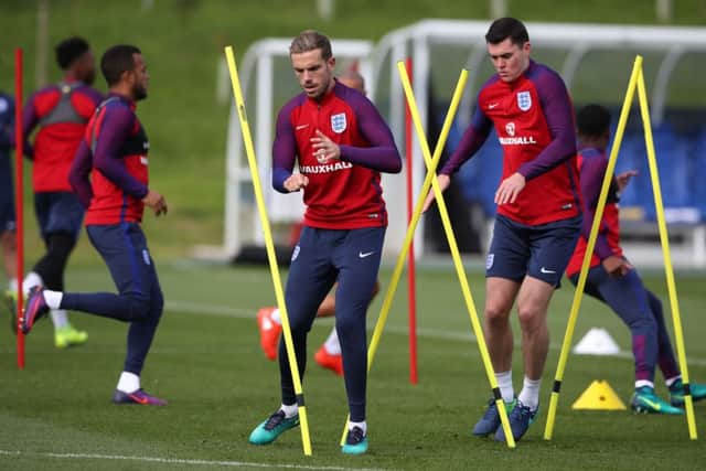 England's Jordan Henderson, left, and Michael Keane train ahead of Saturday's World Cup qualifier against Malta. Picture: Nick Potts/PA
