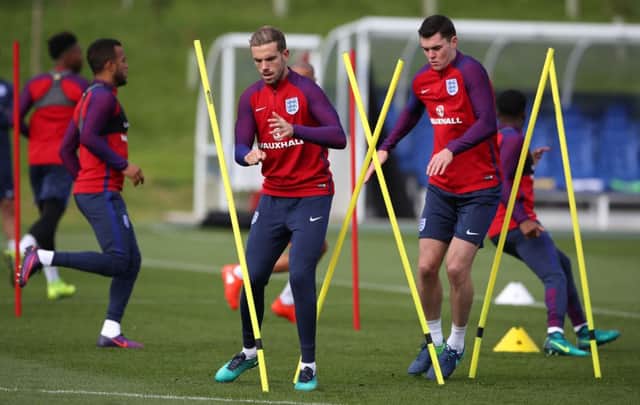 England's Jordan Henderson, left, and Michael Keane train ahead of Saturday's World Cup qualifier against Malta. Picture: Nick Potts/PA