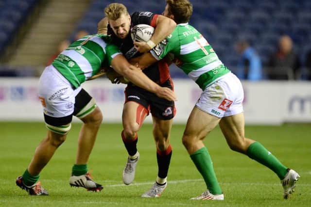 Edinburgh's Tom Brown (centre) breaks through from Treviso's Benvenuti Tommaso (right) and Buondonno Andrea. Picture: SNS