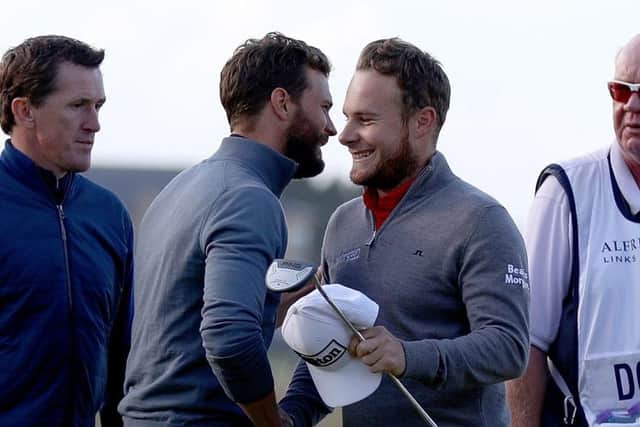 Tyrrell Hatton, right, is congratulated by his playing partner Fifty Shades of Grey actor Jamie Dornan after his round. Picture: Ian Walton/Getty Images