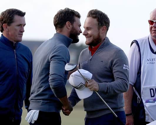 Tyrrell Hatton, right, is congratulated by his playing partner Fifty Shades of Grey actor  Jamie Dornan after his round. Picture: Ian Walton/Getty Images