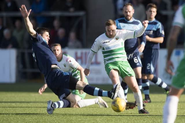 Forfar's Stuart Malcom (left) battles for the ball against The New Saints' Jon Routledge. Picture: SNS