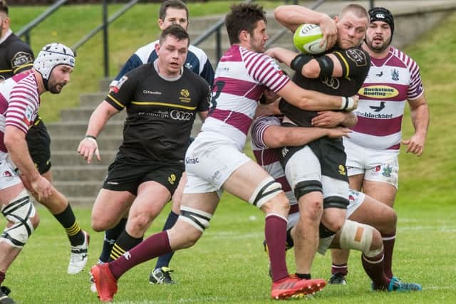 Ruaridh Knott is tackled by Matt Poole. Picture Ian Georgeson