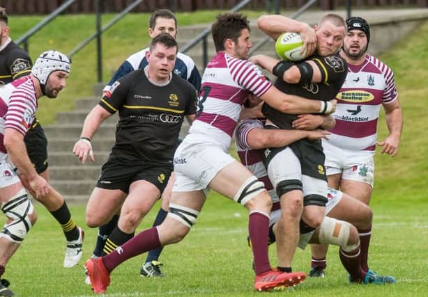 Ruaridh Knott is tackled by Matt Poole. Picture Ian Georgeson