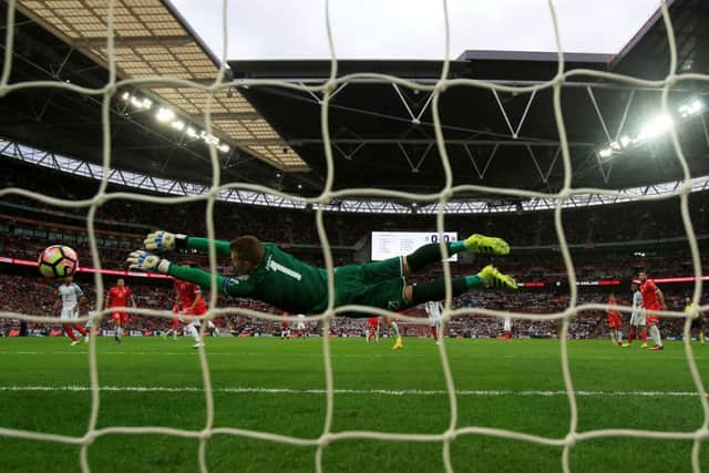 Daniel Sturridge scores his sides first goal as Maltas Andrew Hogg dives in vain.  Photograph: Nick Potts/PA