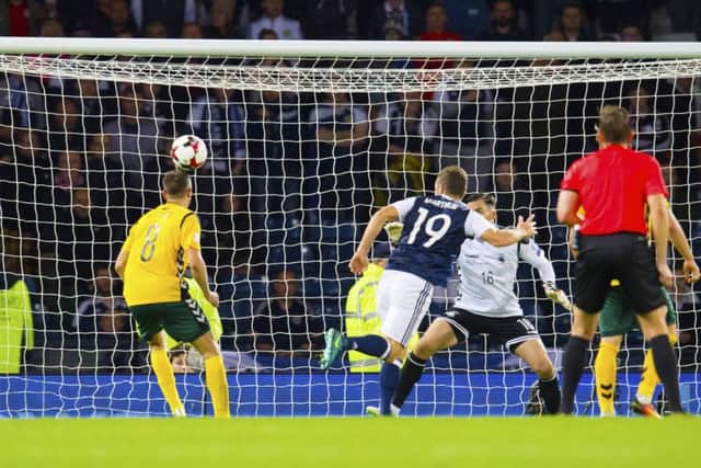 James McArthur heads Scotland level late in the match. Picture: SNS