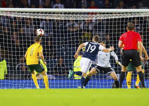 James McArthur heads Scotland level late in the match. Picture: SNS