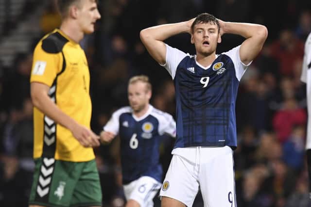 Scotland's Chris Martin has his hands on his head after missing a chance. Picture: SNS