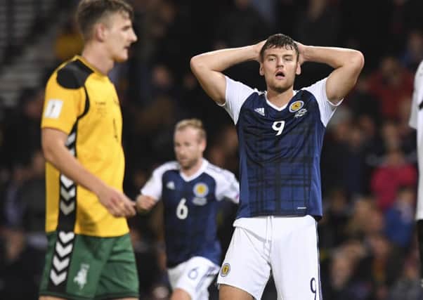 Scotland's Chris Martin has his hands on his head after missing a chance. Picture: SNS