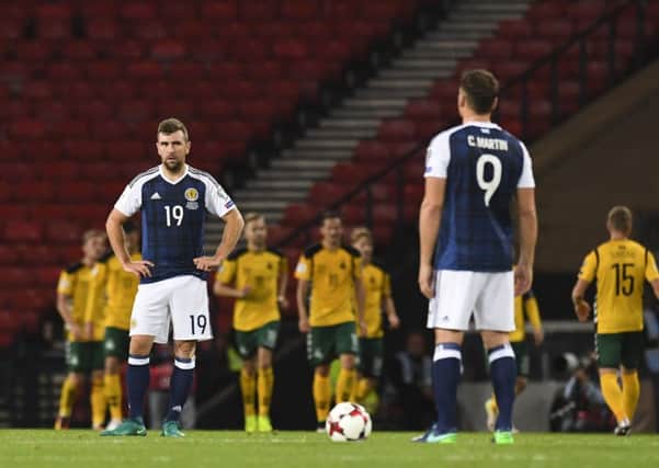 James McArthur (left) and Chris Martin cut dejected figures after Lithuania take the lead. Picture: SNS