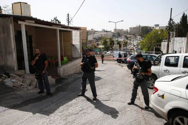 Israeli security forces stand guard at the site of a shooting attack near Israeli police headquarters, Picture; AP