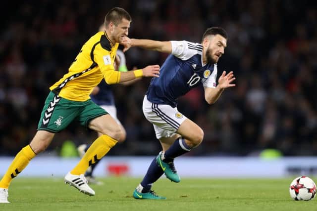 Lithuania's Mantas Kuklys and Scotland's Robert Snodgrass tussle for possession during the World Cup qualifier at Hampden. Picture: Owen Humphreys/PA
