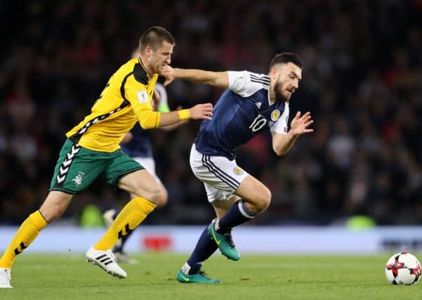 Lithuania's Mantas Kuklys and Scotland's Robert Snodgrass tussle for possession during the World Cup qualifier at Hampden. Picture: Owen Humphreys/PA