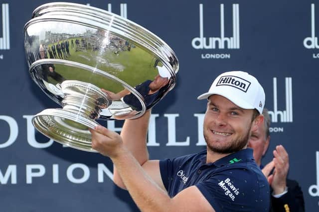 Tyrrell Hatton holds the trophy aloft on the 18th green after winning the Alfred Dunhill Links Championship at The Old Course in St Andrews.  Picture: Richard Heathcote/Getty