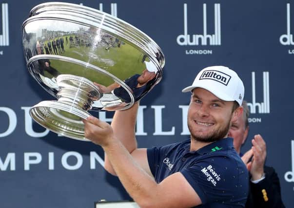 Tyrrell Hatton holds the trophy aloft on the 18th green after winning the Alfred Dunhill Links Championship at The Old Course in St Andrews.  Picture: Richard Heathcote/Getty