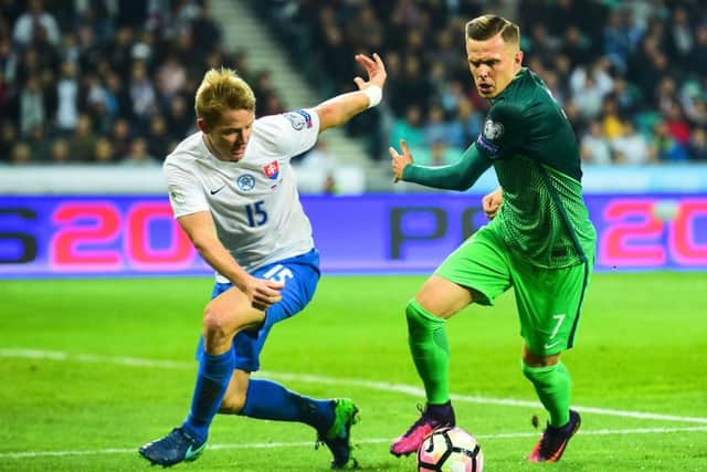 Slovakia's Tomas Hubocan vies for the ball with Slovenia's Josip Ilicic. Picture: AFP/Getty Images